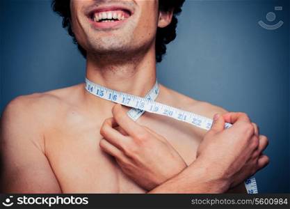 Young man measuring his neck
