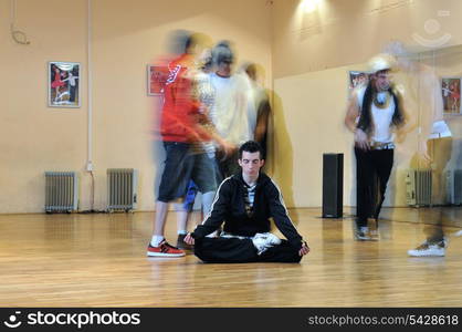 young man meditating in lotus position at dance studio