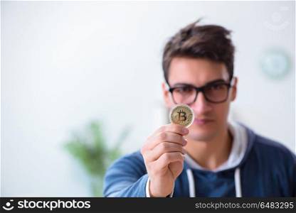 Young man mining bitcoins at home