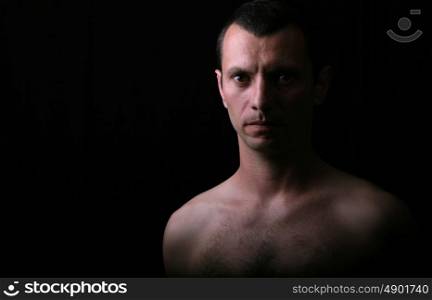 young man model on a black background and very low light