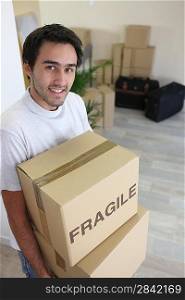 Young man moving boxes marked f