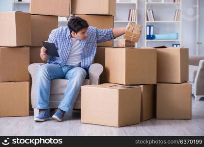 Young man moving in to new house with boxes
