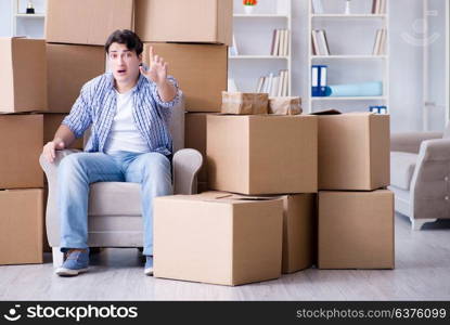 Young man moving in to new house with boxes