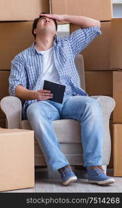 Young man moving in to new house with boxes. The young man moving in to new house with boxes