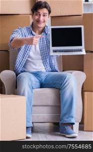 Young man moving in to new house with boxes. The young man moving in to new house with boxes