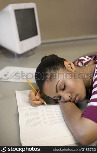 Young man napping on a book