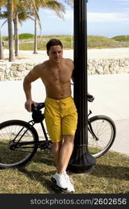 Young man on bicycle on beach