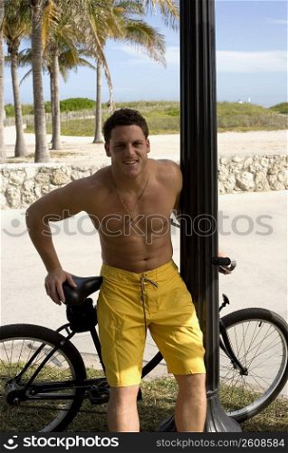 Young man on bicycle on beach