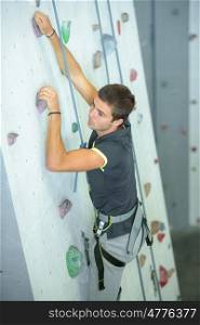 Young man on climbing wall