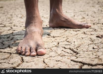Young man on dry soil