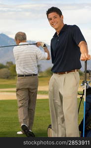 Young Man on Golf Course with Older man