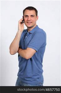 young man on his mobile phone against a white background