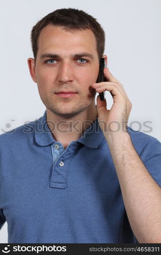 young man on his mobile phone against a white background