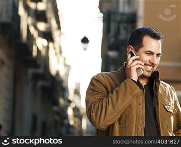 Young man on mobile phone in street