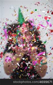 young man on party celebrating new year with falling confetti