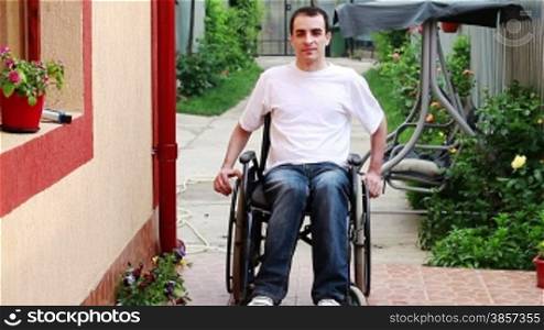 Young man on wheelchair in the yard