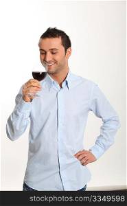 Young man on white background tasting red wine