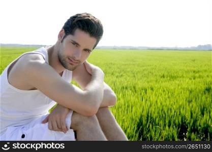 Young man outdoor happy relaxed on green rice field meadow