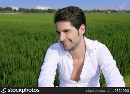 Young man outdoor happy relaxed on green rice field meadow