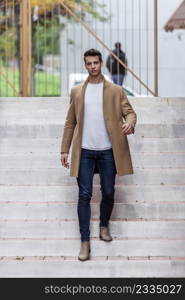 Young man outdoor in winter fashion, wearing woolen jacket in city setting