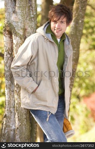 Young Man Outdoors Walking In Autumn Woodland