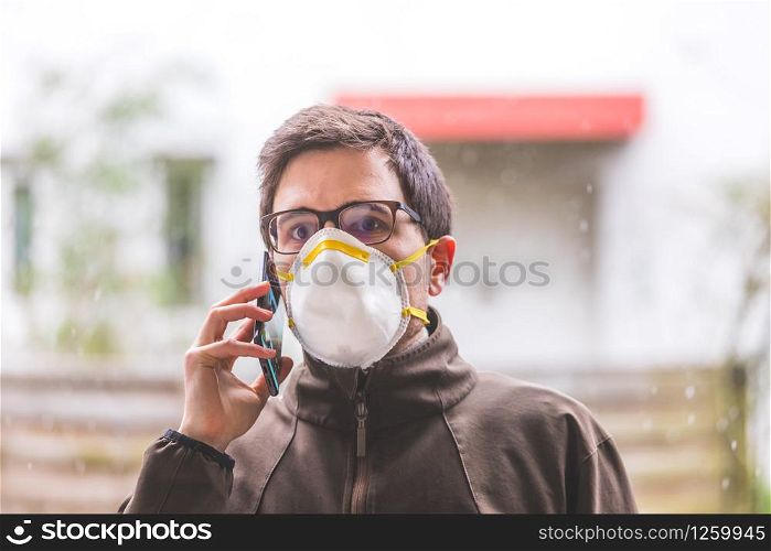 Young man outdoors with a breathing mask. Flue and corona season.