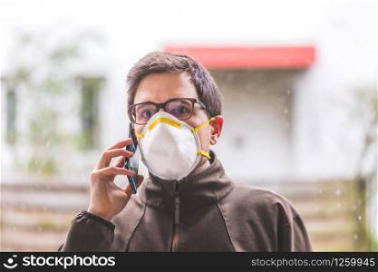 Young man outdoors with a breathing mask. Flue and corona season.