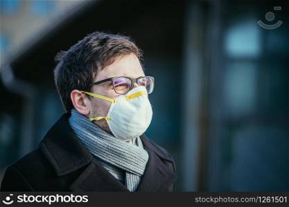 Young man outdoors with a breathing mask. Flue and corona season