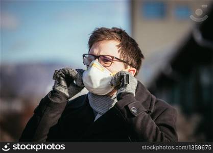Young man outdoors with a breathing mask. Flue and corona season