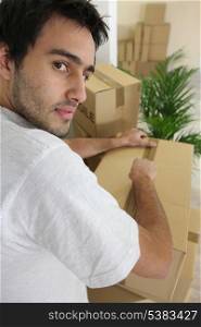 Young man packing boxes