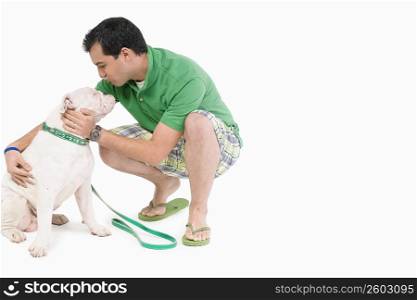 Young man pampering a dog