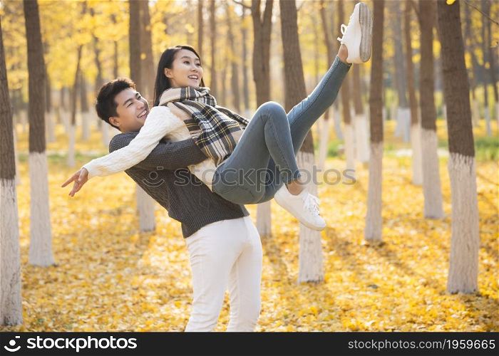 Young man picking up his girlfriend