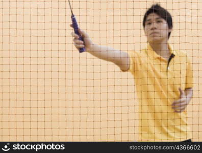 Young man playing badminton