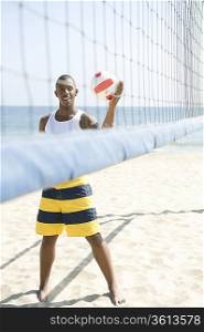Young man playing beach volleyball
