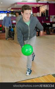 young man playing bowling
