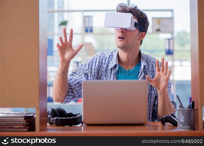 Young man playing computer game with virtual reality glasses