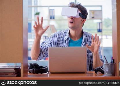 Young man playing computer game with virtual reality glasses