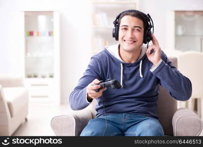 Young man playing computer games at home