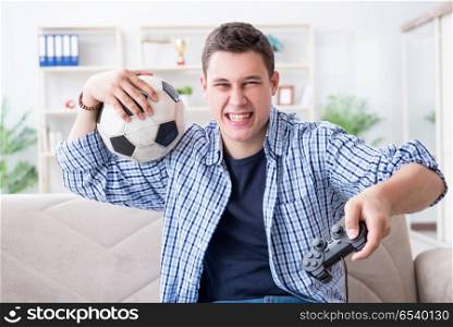Young man playing computer games at home