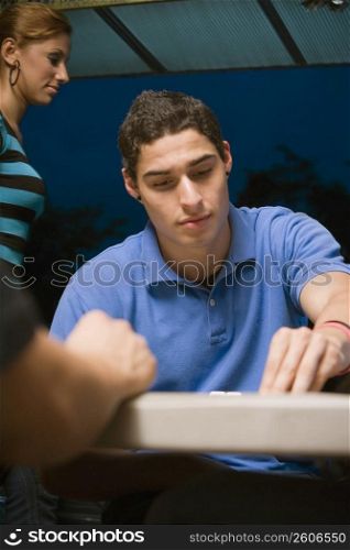 Young man playing dominos