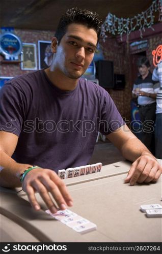 Young man playing dominos