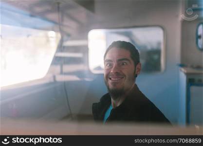 young man playing dumb inside his caravan