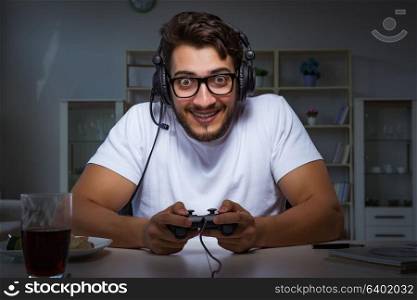 Young man playing games long hours late in the office