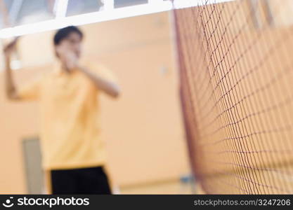 Young man playing in a badminton court