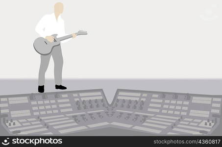 Young man playing the guitar in a recording studio