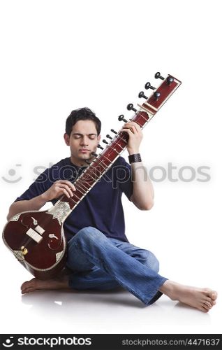 Young man playing the sitar