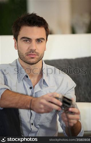 Young man playing video games alone