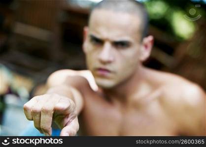 Young man pointing his finger in anger