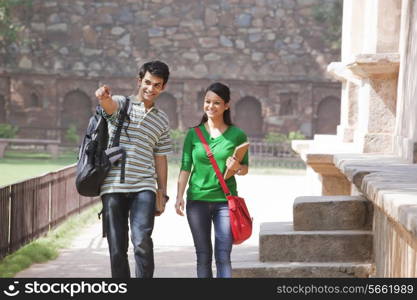 Young man pointing something out to woman