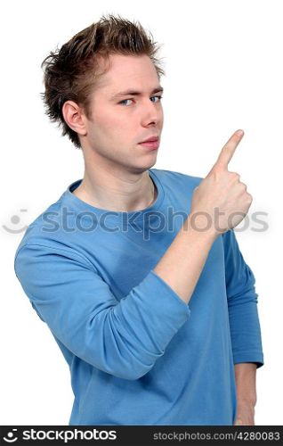 Young man pointing up at copy space